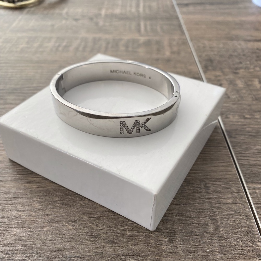 Michael Kors bangle bracelet with diamond logo accent.